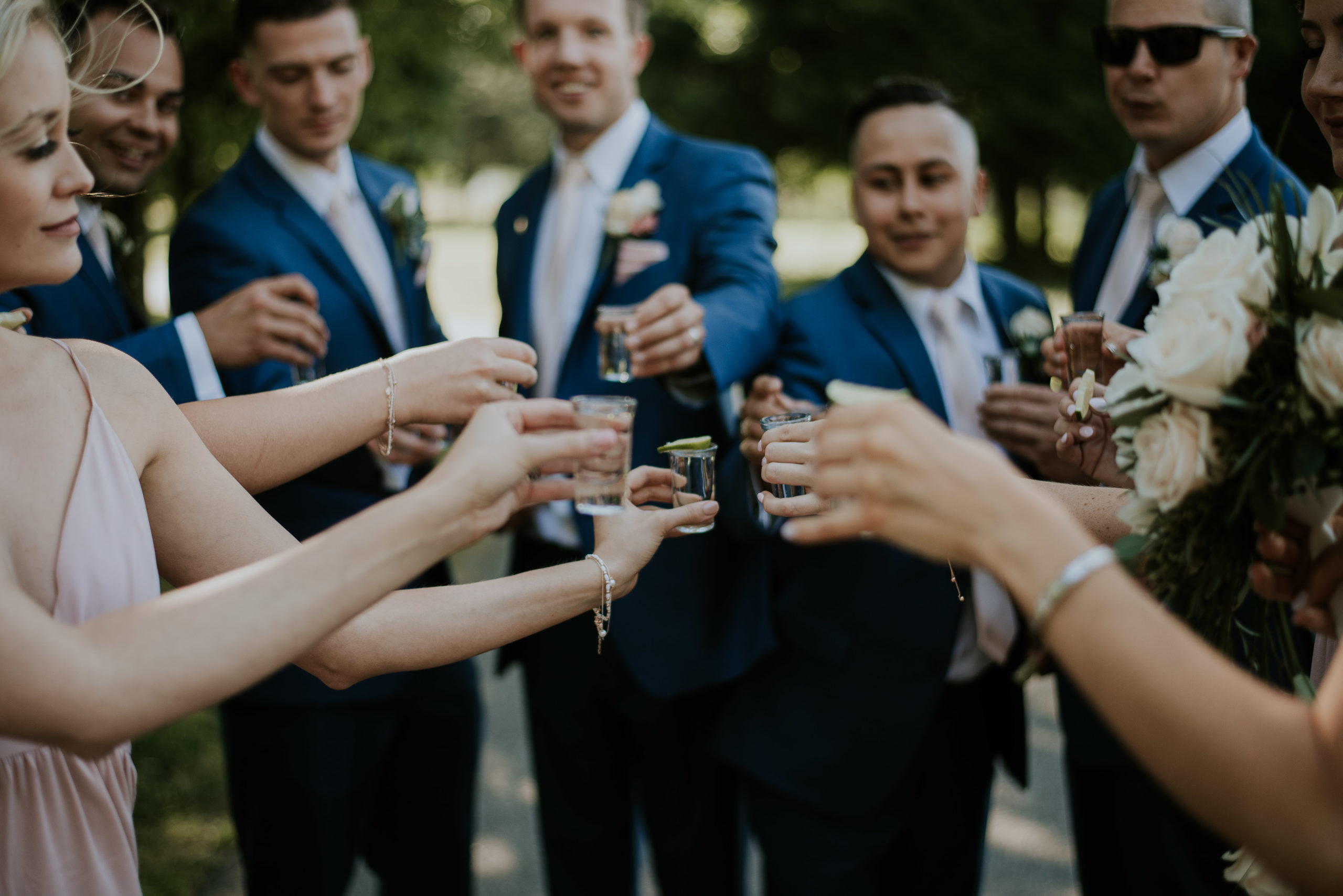 wedding party cheersing tequila shots